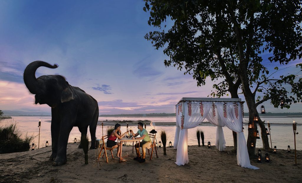 couple having dinner in the bank of Rapti river in Chitwan.