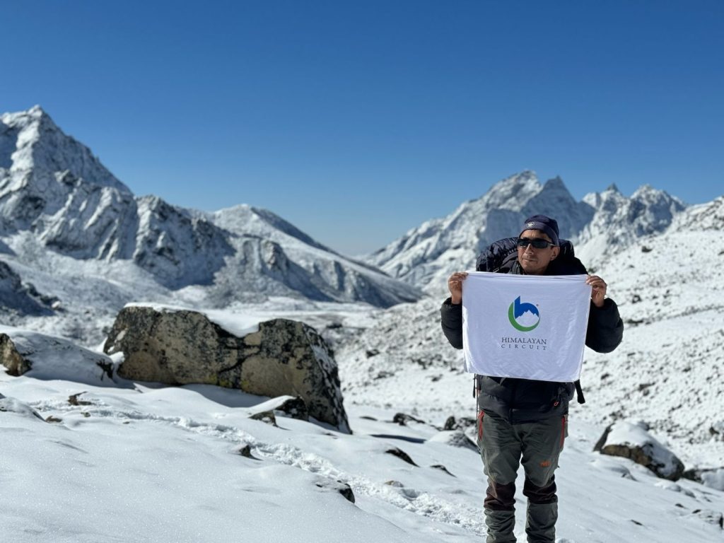Trekking Guide with Himalayan Circuit Banner during Everest Trek.