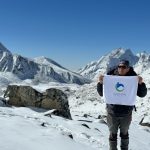 Trekking Guide with Himalayan Circuit Banner during Everest Trek.