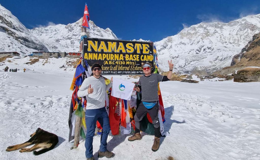 Two Trekkers holding himalayan circuit Banner in Annapurna Base Camp